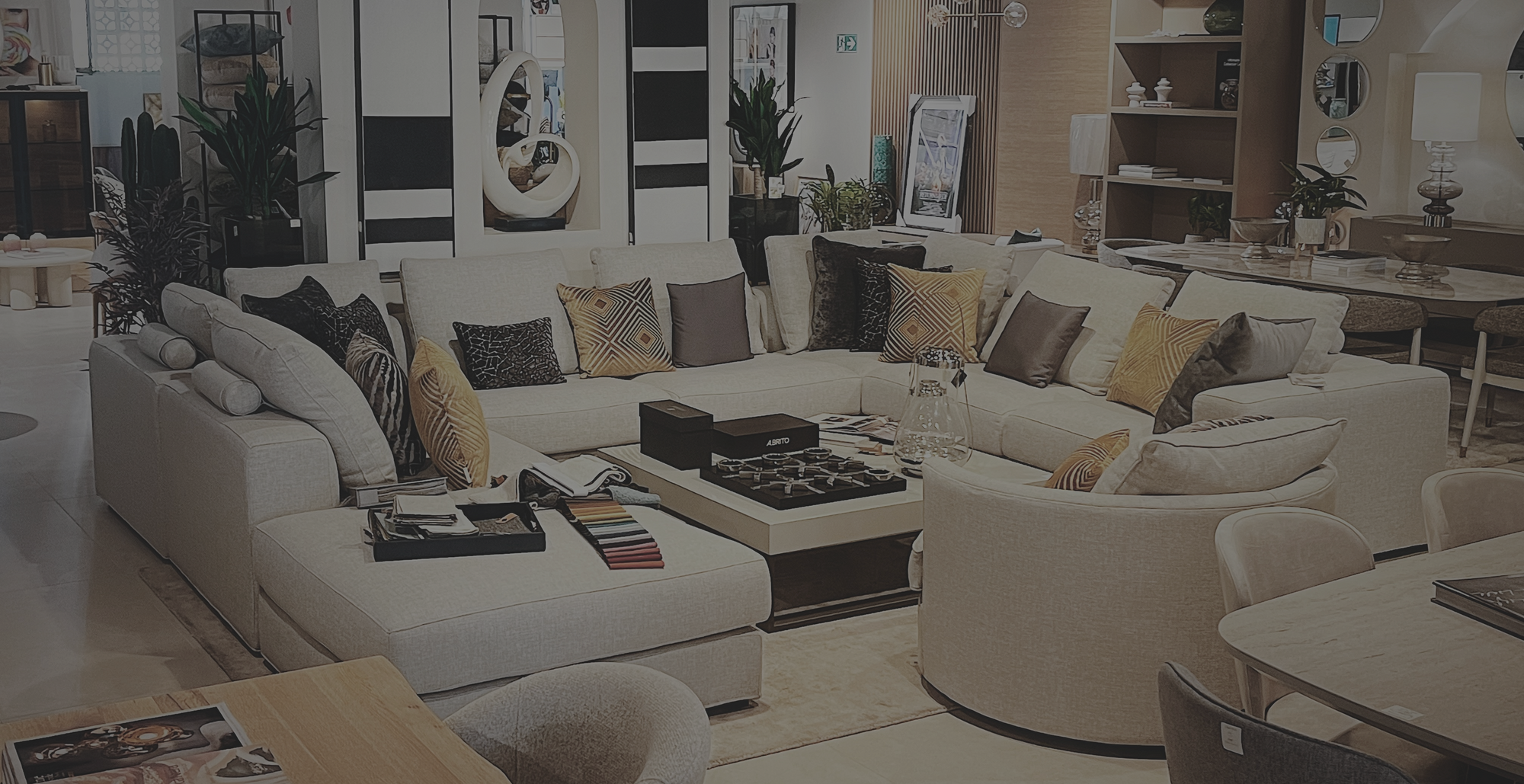 Modern living room with a white sofa, coffee table, and decorative items.