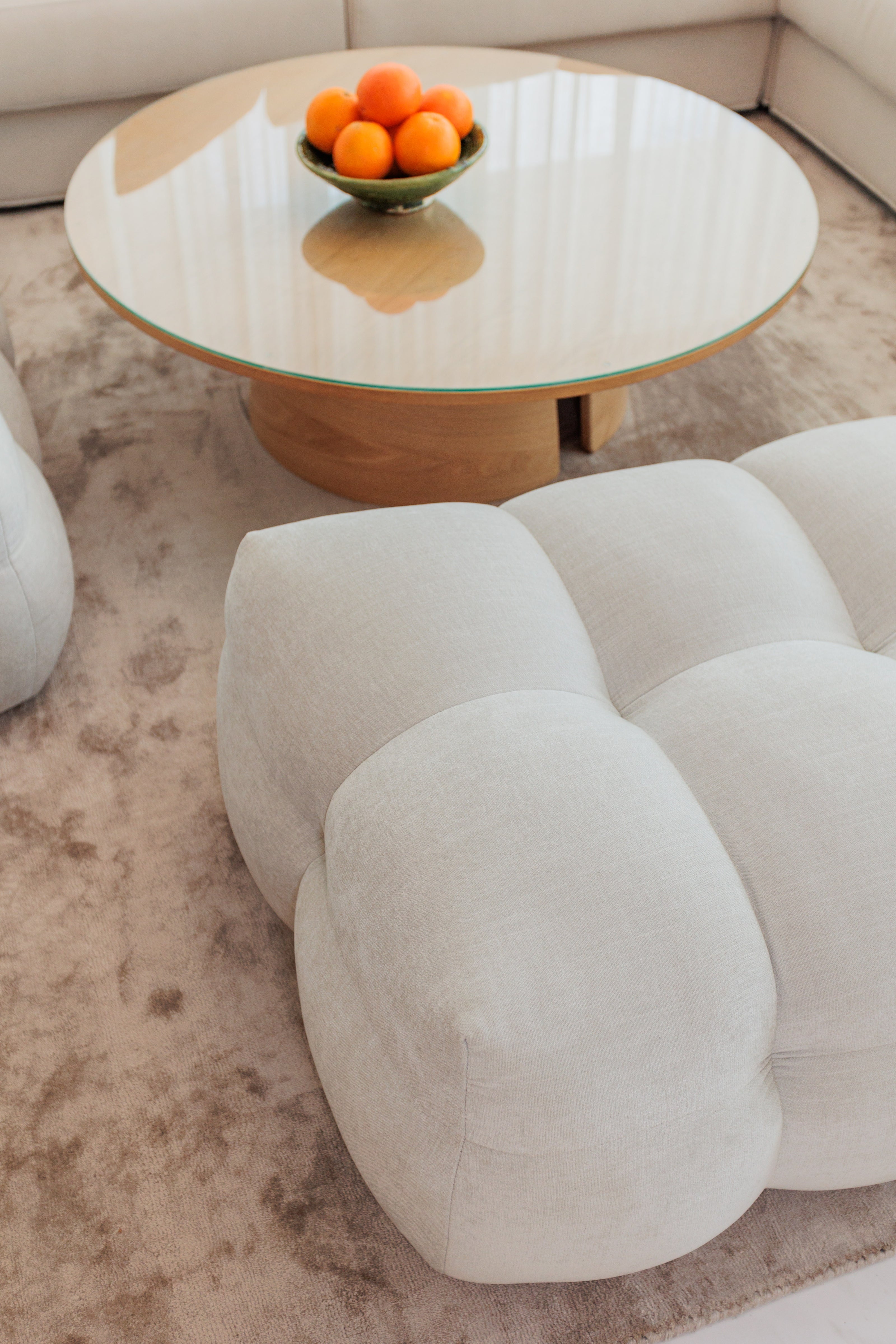 indoor interior design, living room, modern minimalist coffee table, rug, round edge soft pouf available in marbella, benahavis, malaga, costa del sol, estepona.