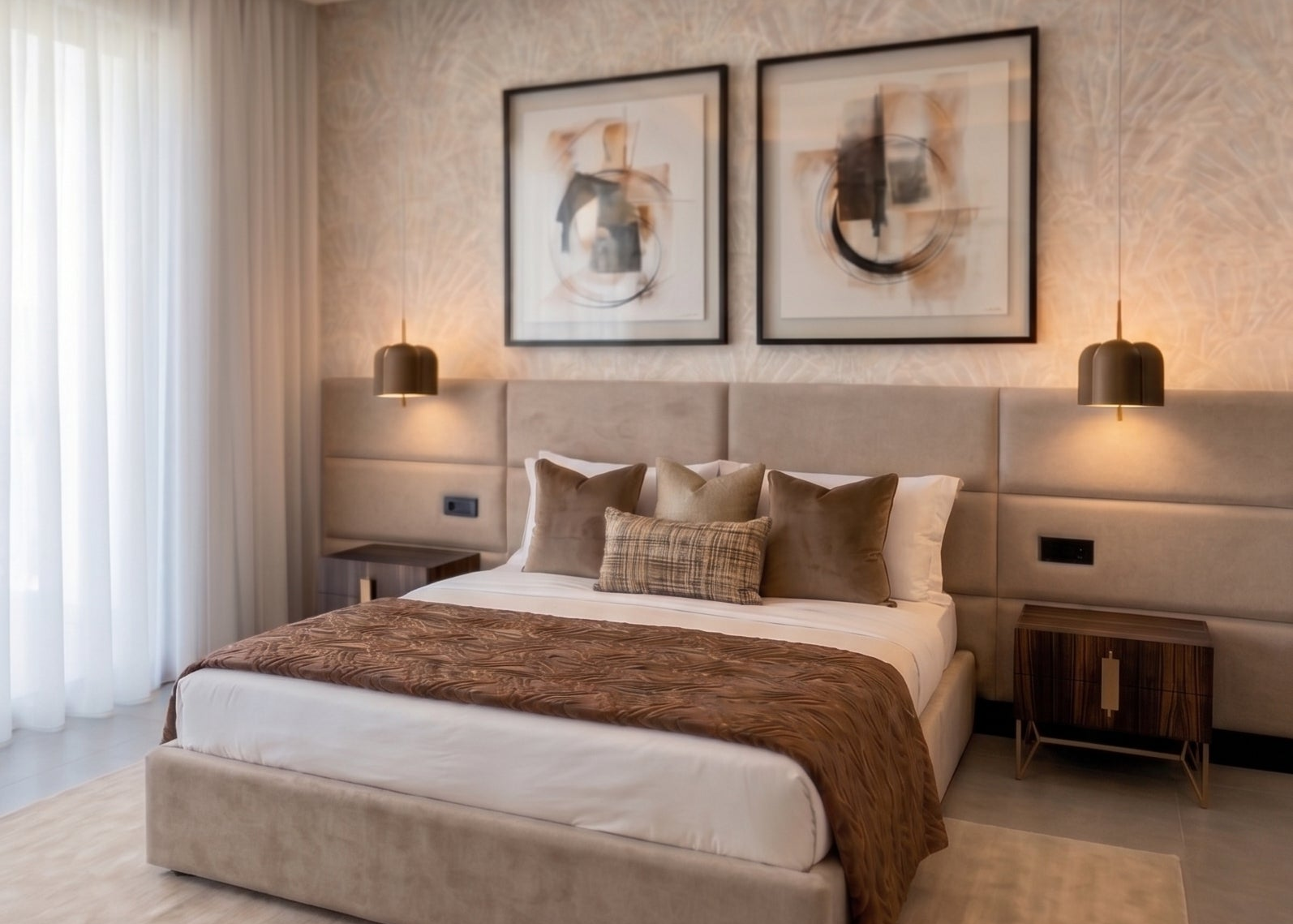 A luxury modern bedroom featuring a large bed with beige upholstered headboard and footboard, white bedding, a brown patterned throw blanket, matching pillows, and two dark wood nightstands with lit pendant lamps.