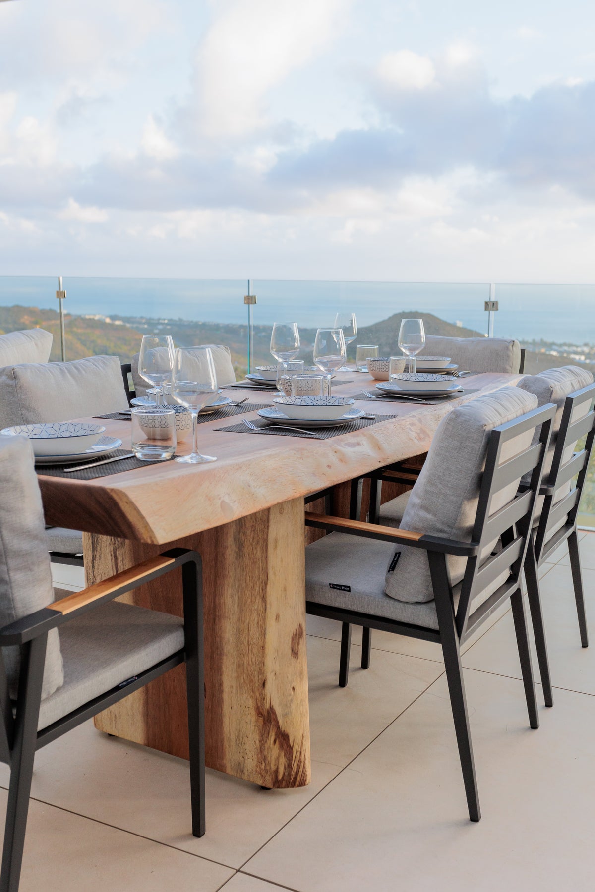 luxury interior design for outdoor furniture with wooden outdoor dining table, aluminium dining chair, glassware on the table available in costa del sol, marbella, malaga.