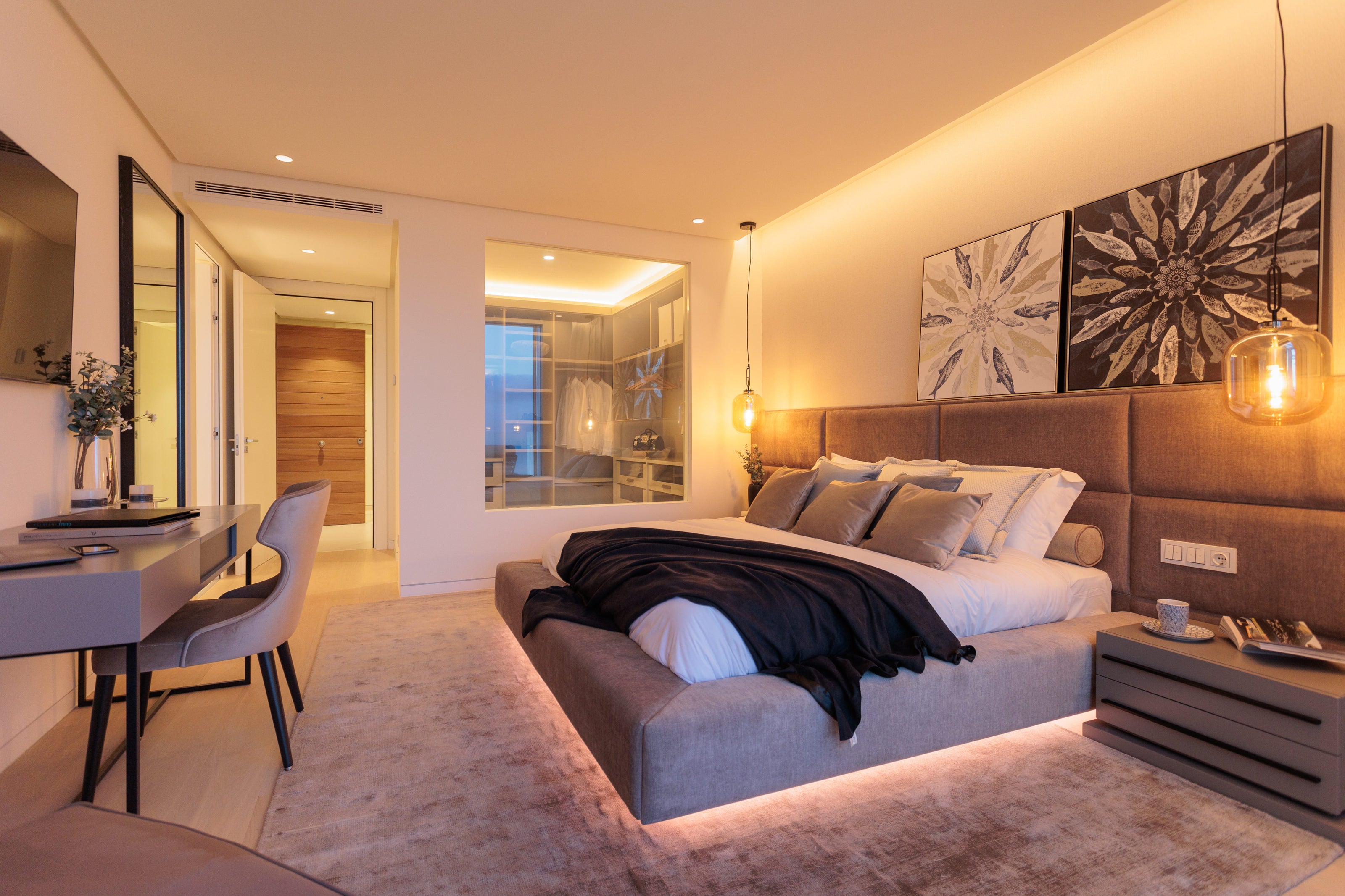 modern contemporary interior design for bedroom with floating bed with led lights, headboard, bedside table, rug, ceiling lamp, table available in casares, bel air, marbella, malaga, costa del sol.