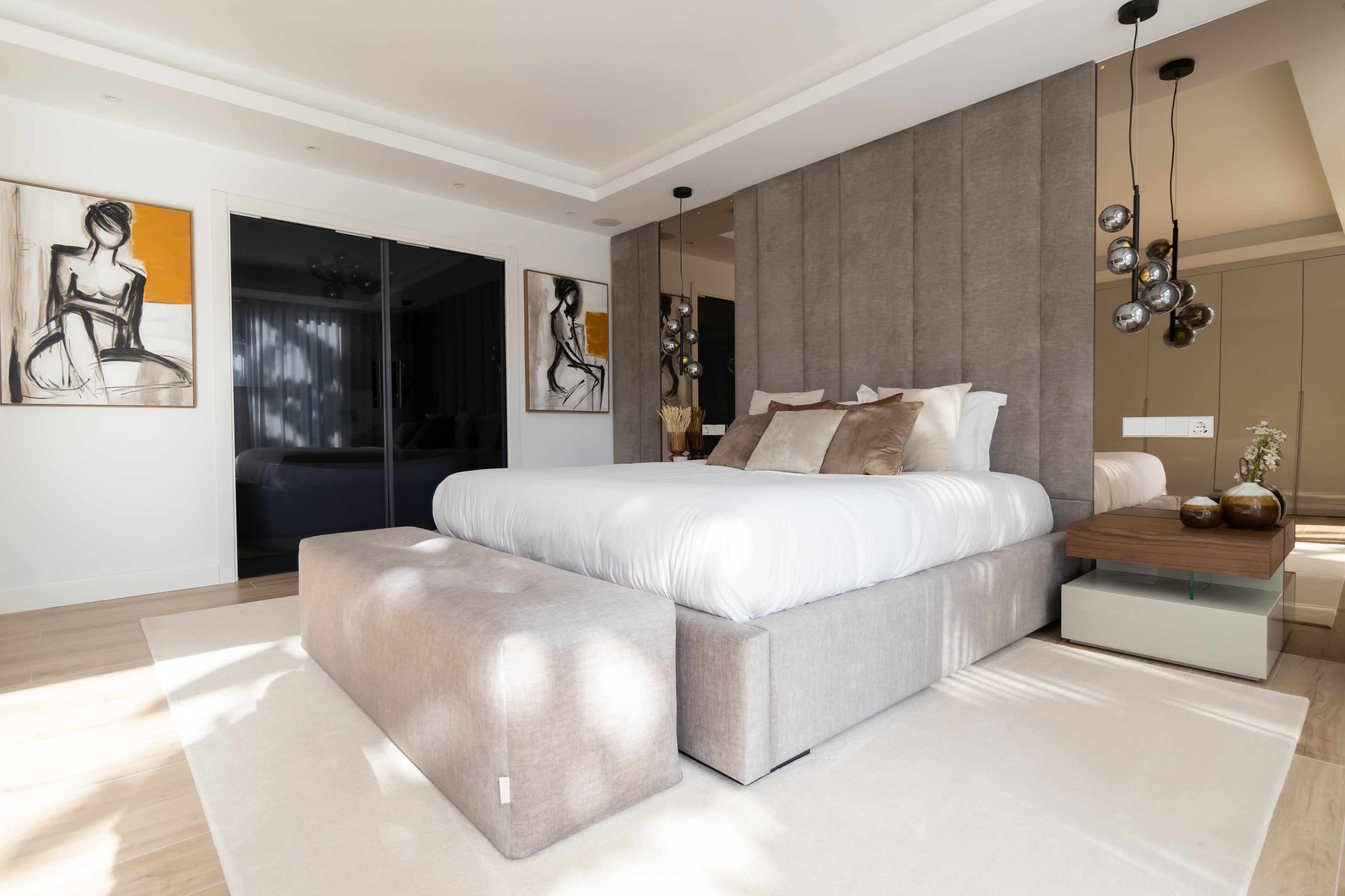 Interior design project for bedroom with mirrors, elegant bed, ottoman, rug, bedside table, bronze mirror and artworks available in benalmadena, alcazaba, malaga, marbella, costa del sol